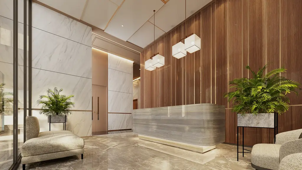 A bright hotel lobby with a reception desk and lounge seating