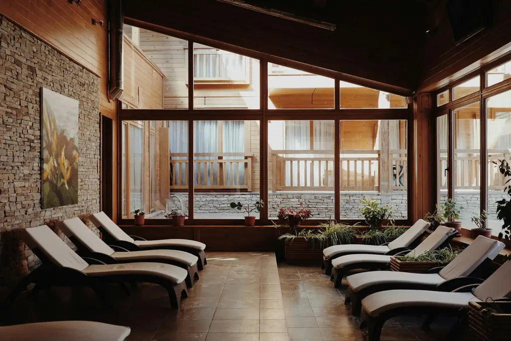 Loungers in a quiet spa relaxation room with tall windows